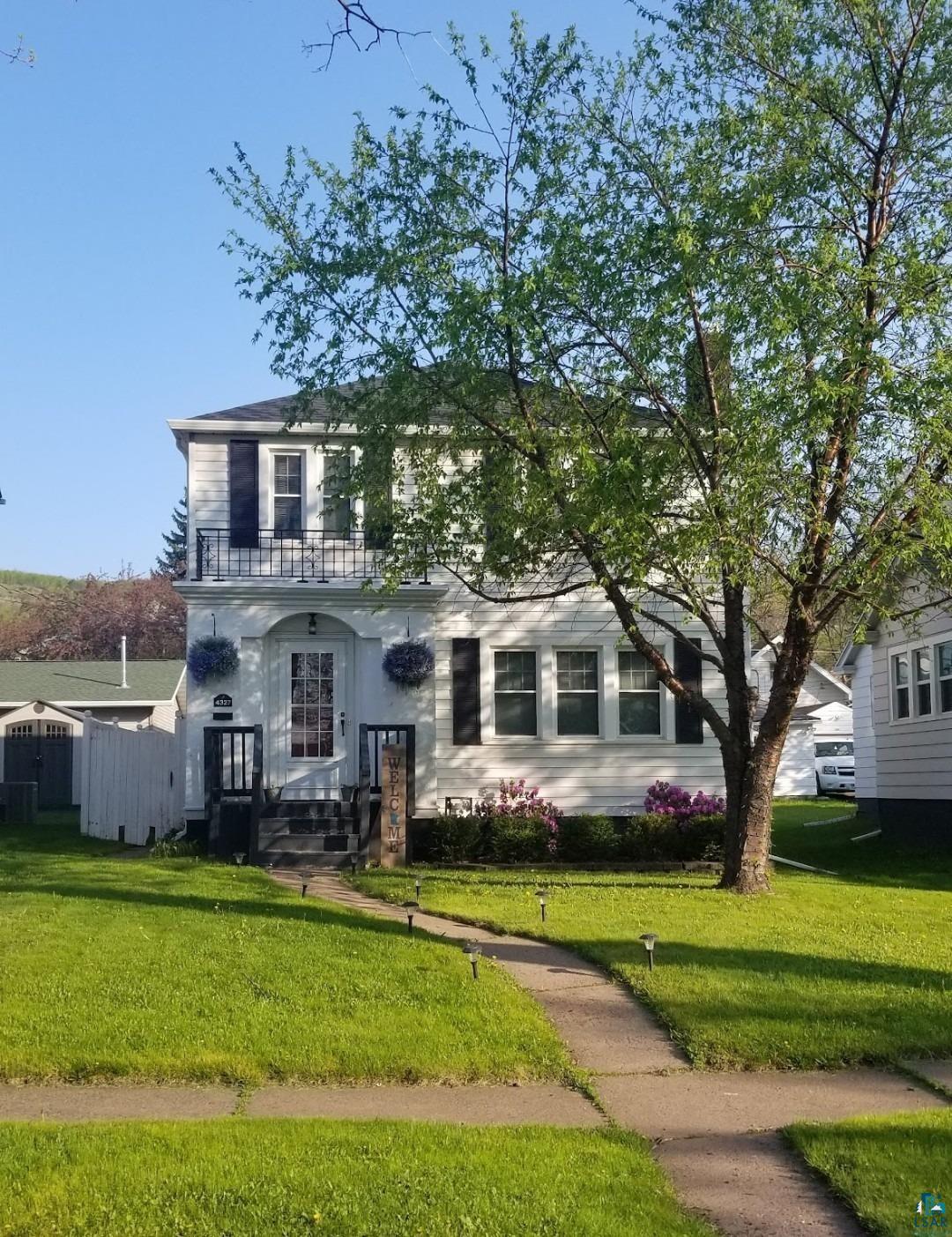4327 West 5th Street Duluth, MN 55807 - Photo 1 of 25 View of front facade with a balcony and a front lawn
