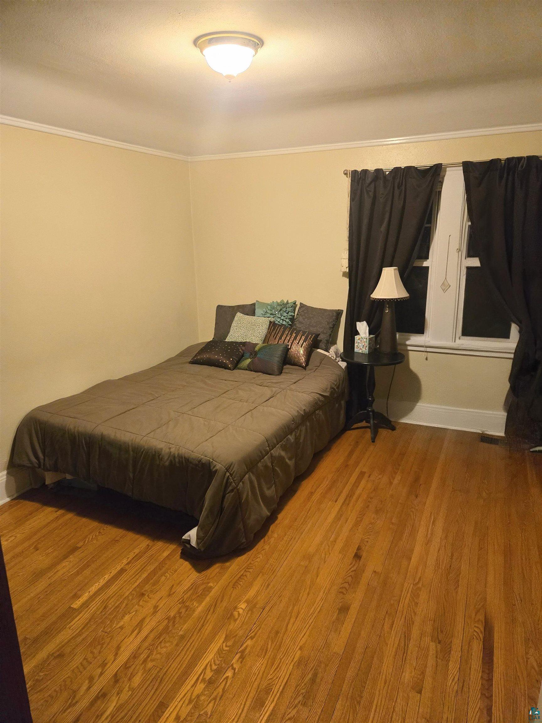 4327 West 5th Street Duluth, MN 55807 - Photo 16 of 25 Bedroom featuring wood finished floors and ornamental molding