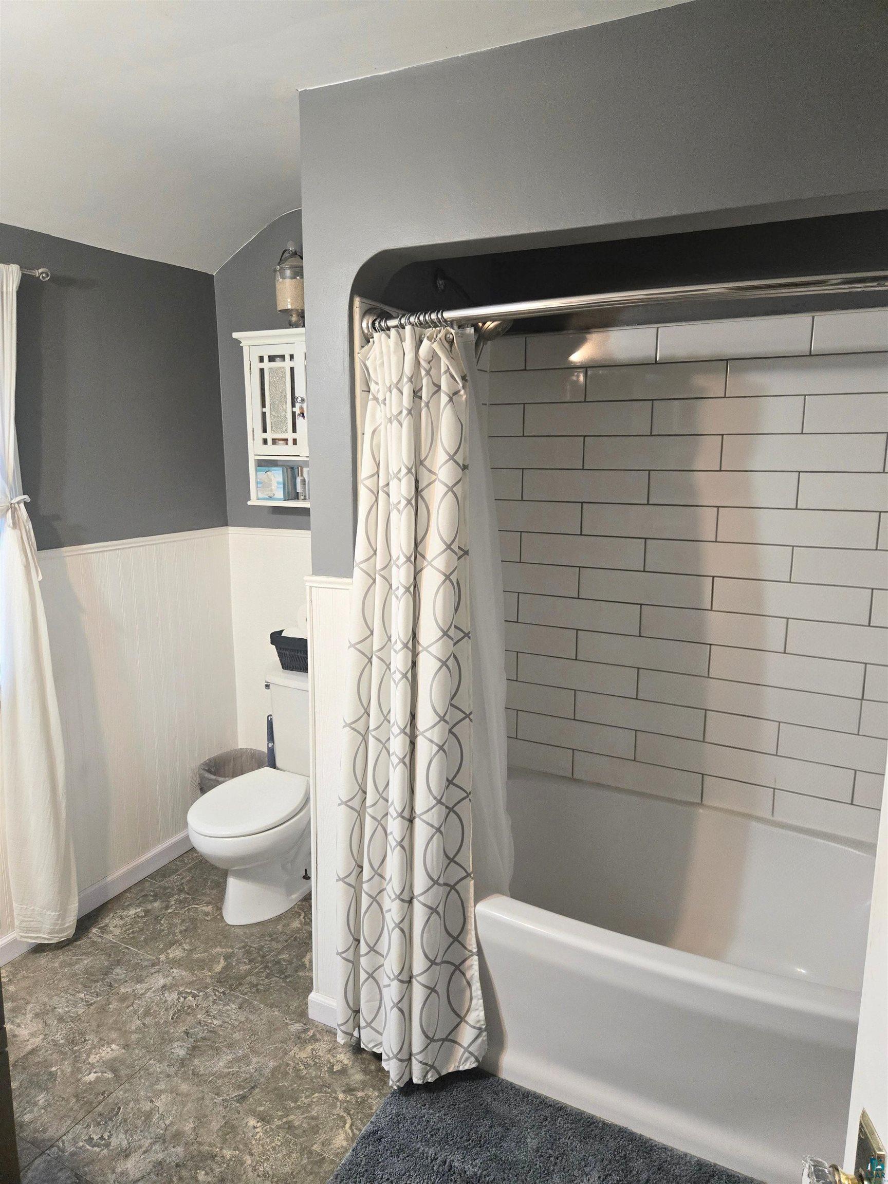 4327 West 5th Street Duluth, MN 55807 - Photo 18 of 25 Bathroom with a wainscoted wall and shower / bath combo