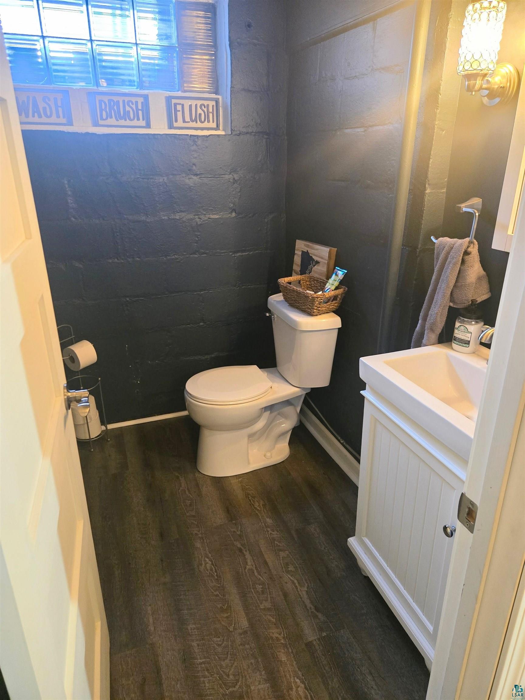 4327 West 5th Street Duluth, MN 55807 - Photo 20 of 25 Half bathroom with vanity and dark wood-type flooring