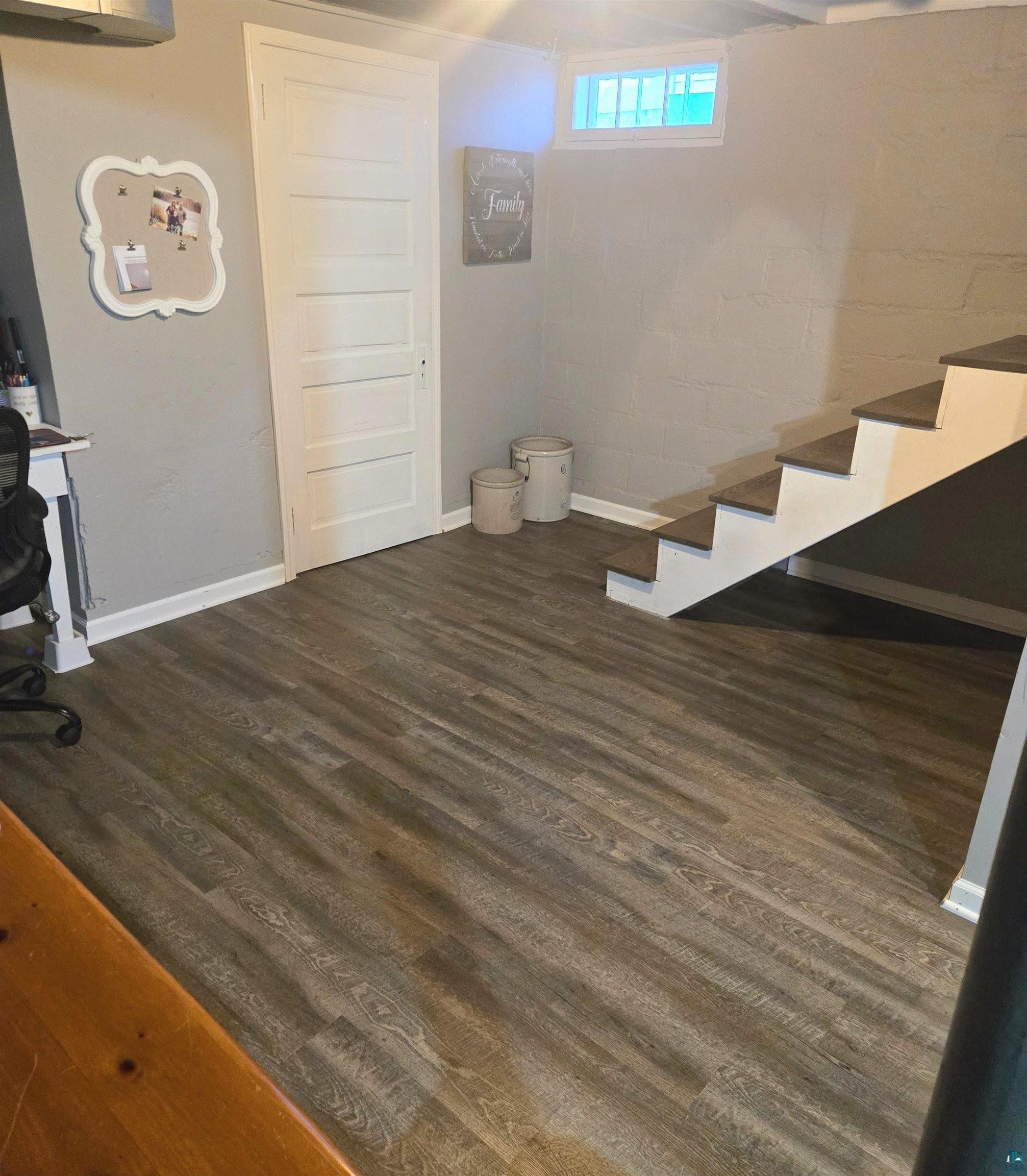 4327 West 5th Street Duluth, MN 55807 - Photo 22 of 25 Below grade area with stairs and dark wood-type flooring