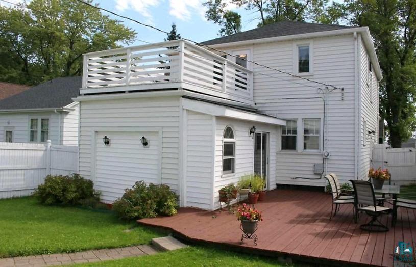4327 West 5th Street Duluth, MN 55807 - Photo 24 of 25 Rear view of house featuring a balcony, a wooden deck, and outdoor dining area