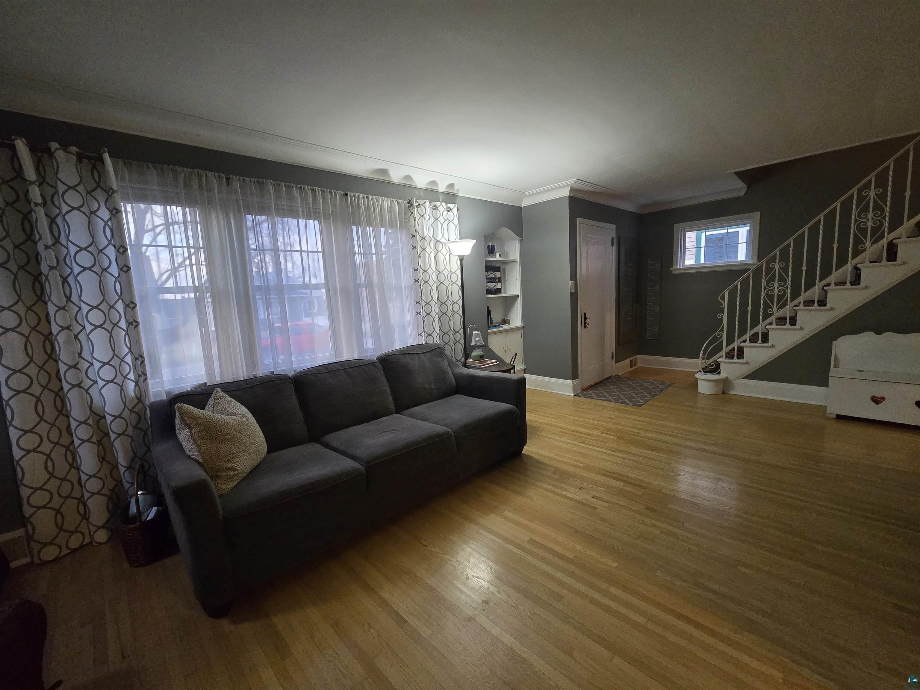 4327 West 5th Street Duluth, MN 55807 - Photo 6 of 25 Living room featuring wood finished floors and crown molding