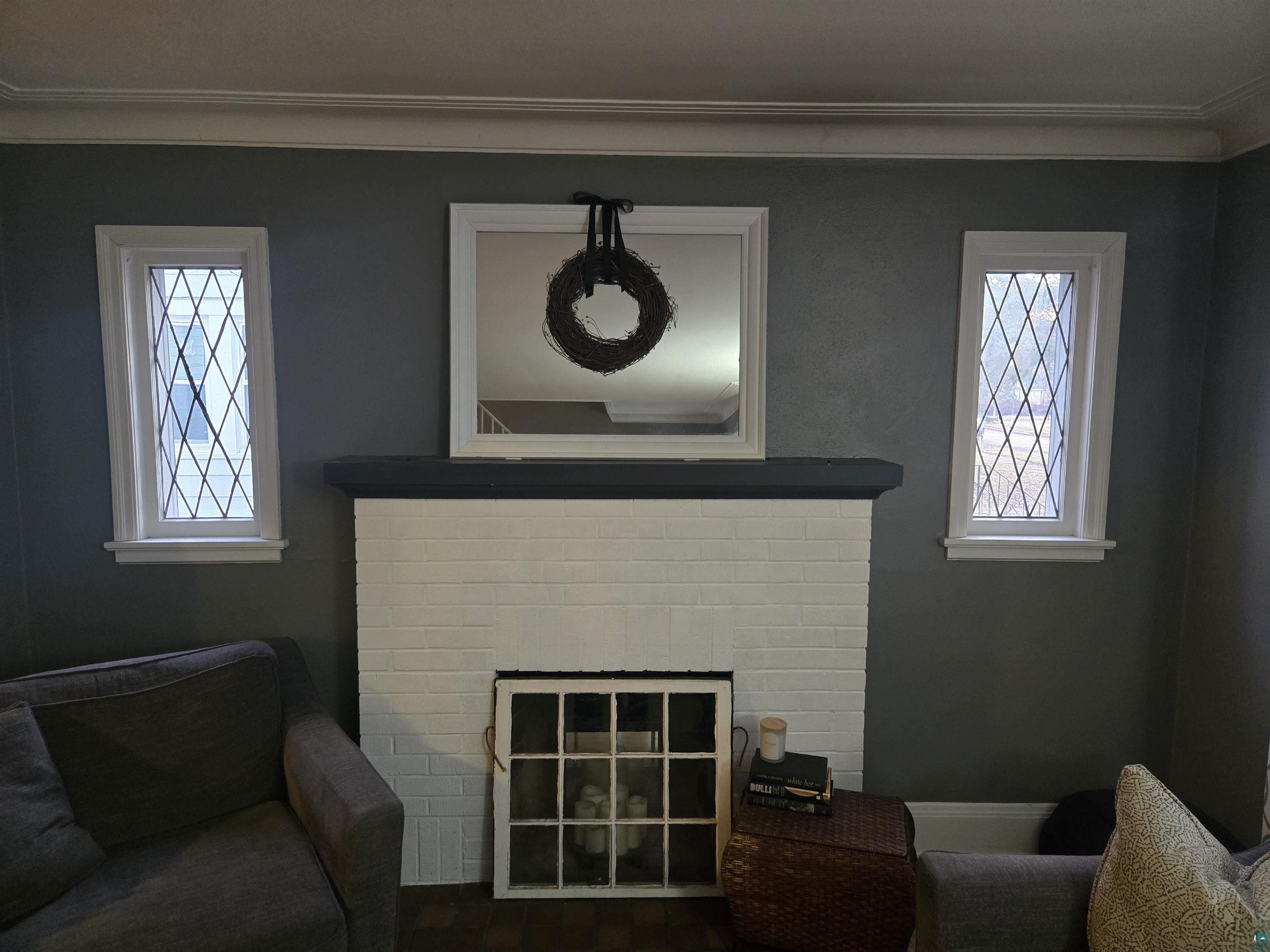 4327 West 5th Street Duluth, MN 55807 - Photo 8 of 25 Living room with a fireplace and crown molding