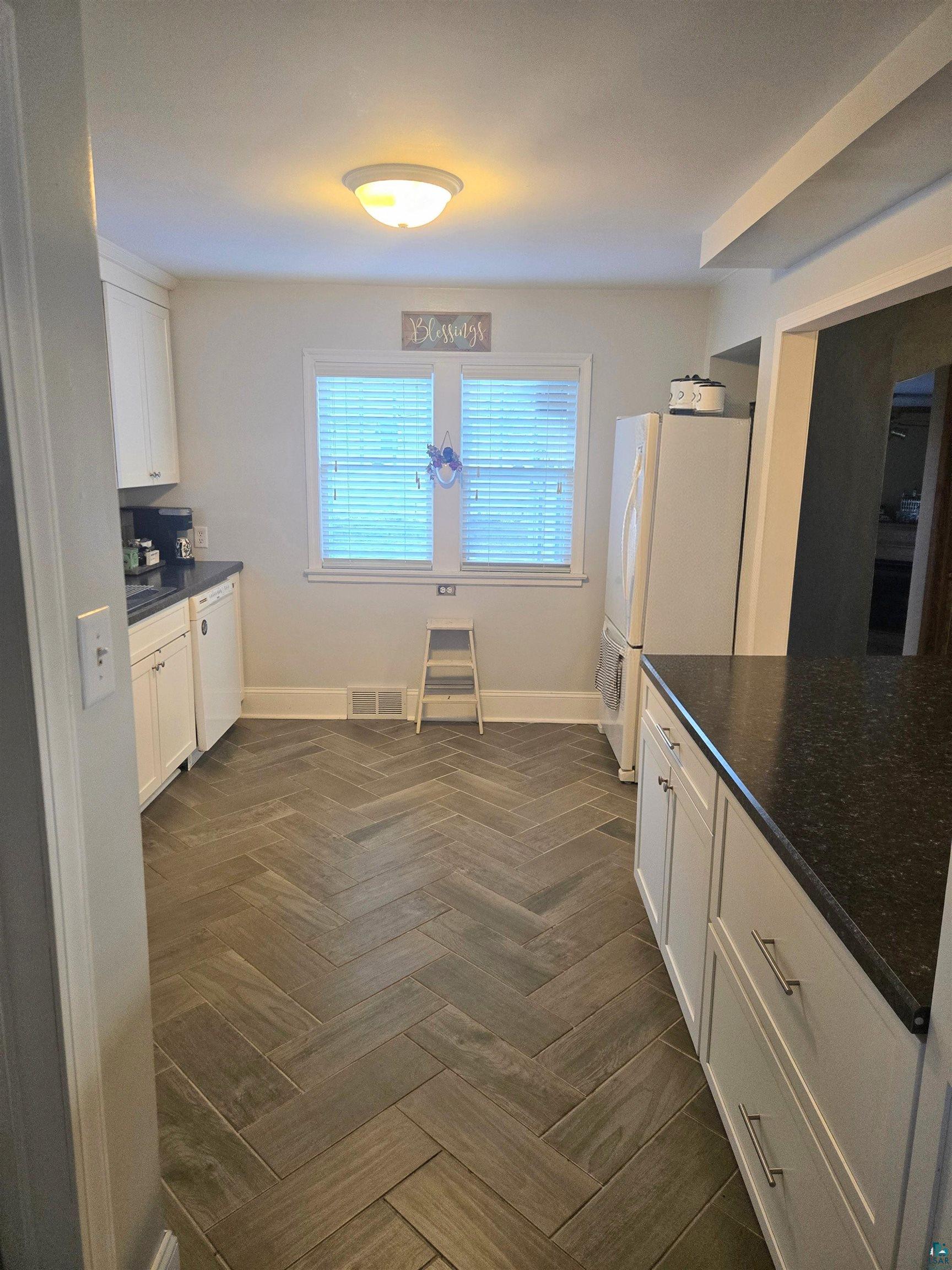 4327 West 5th Street Duluth, MN 55807 - Photo 10 of 25 Kitchen featuring white cabinetry, white appliances, and parquet floors