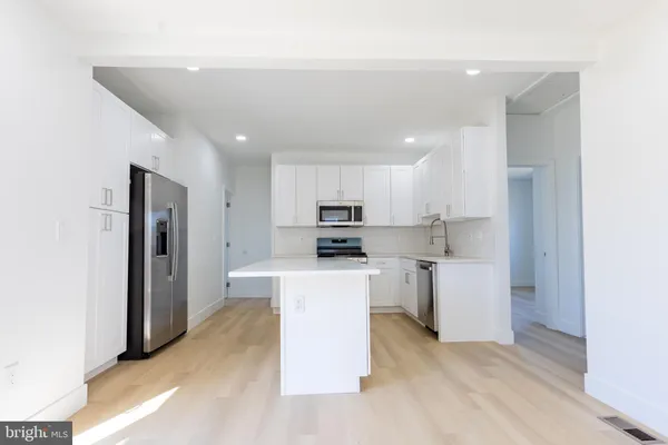 a kitchen with cabinets and stainless steel appliances