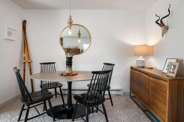 a view of a dining room with furniture and a mirror