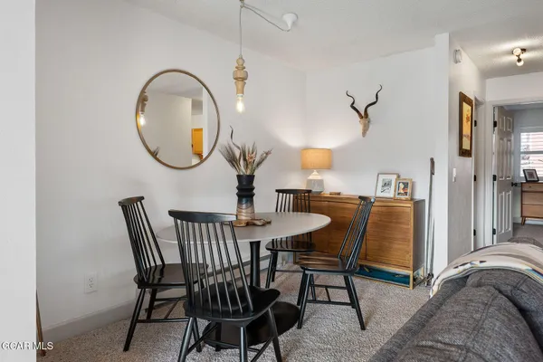 a dining room with furniture and wooden floor