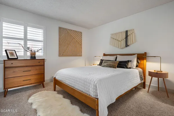 a view of a dining room with furniture and a chandelier