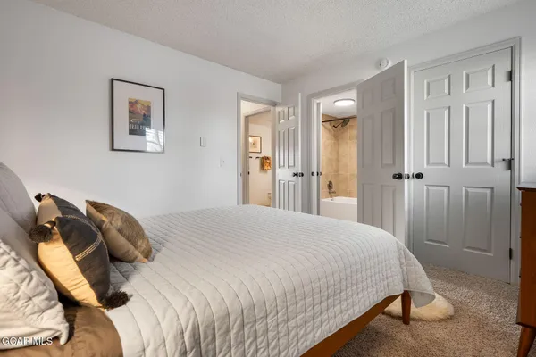 a bedroom with a bed and lamp