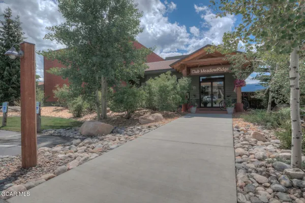 a view of a patio with table and chairs and potted plants