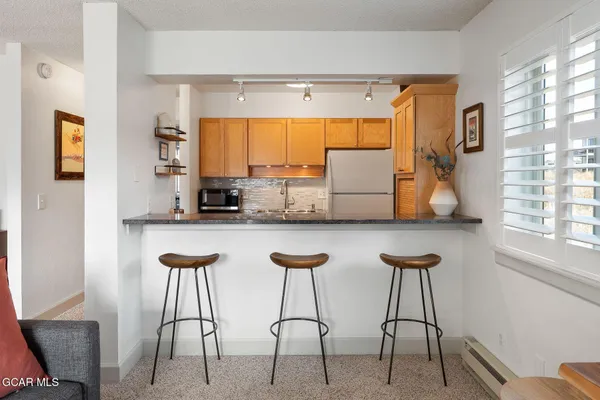 a kitchen with stainless steel appliances a counter top space and a window