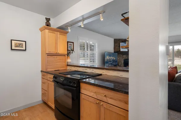 a kitchen with stainless steel appliances granite countertop a stove and a refrigerator