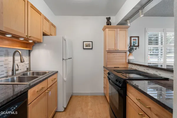 a kitchen that has a sink and a stove