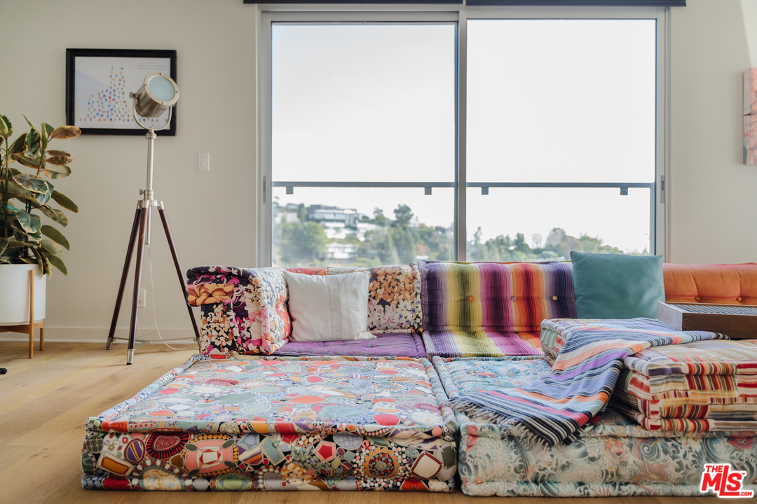 9318 Warbler Way Los Angeles, CA 90069 - Photo 15 of 46 a bedroom with furniture and a floor to ceiling window