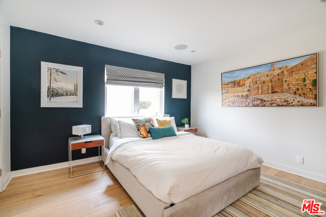 9318 Warbler Way Los Angeles, CA 90069 - Photo 17 of 46 a bedroom with a bed and a painting on the wall
