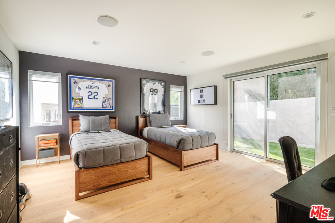 9318 Warbler Way Los Angeles, CA 90069 - Photo 20 of 46 a bedroom with a large bed and a large window