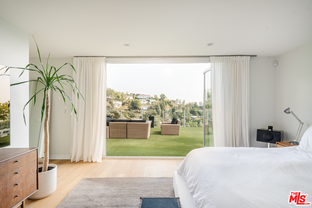 9318 Warbler Way Los Angeles, CA 90069 - Photo 26 of 46 a bedroom with a bed and a window