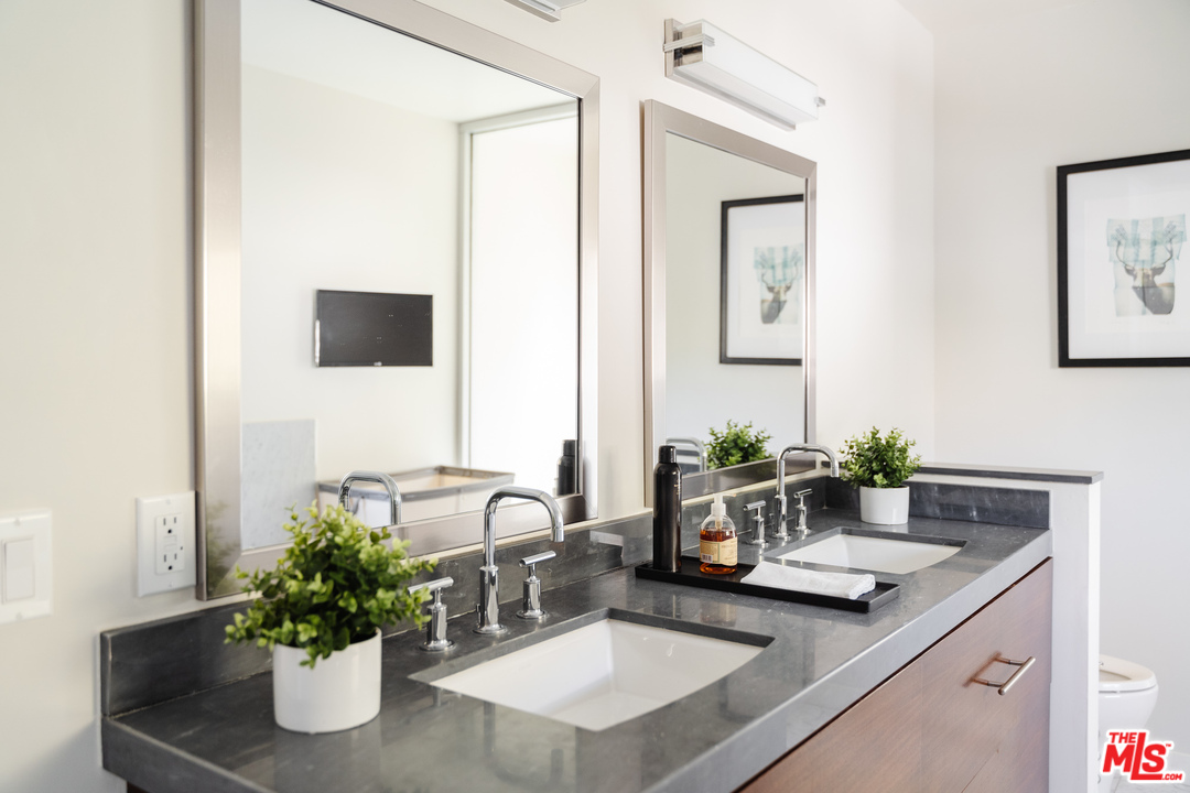 9318 Warbler Way Los Angeles, CA 90069 - Photo 29 of 46 a bathroom with a sink and a mirror