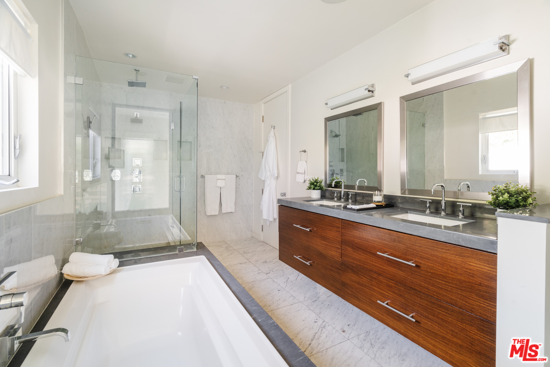 9318 Warbler Way Los Angeles, CA 90069 - Photo 30 of 46 a spacious bathroom with a tub sink shower and mirror