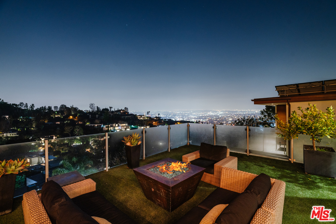 9318 Warbler Way Los Angeles, CA 90069 - Photo 45 of 46 an outdoor sitting area with a table and chairs