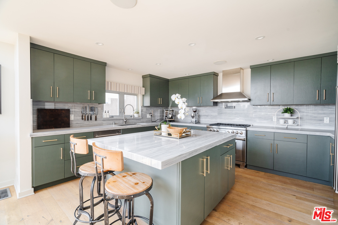9318 Warbler Way Los Angeles, CA 90069 - Photo 8 of 46 a kitchen with a sink cabinets and wooden floor