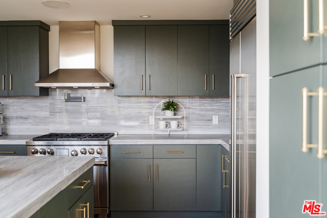 9318 Warbler Way Los Angeles, CA 90069 - Photo 9 of 46 a kitchen with a sink a stove and cabinets