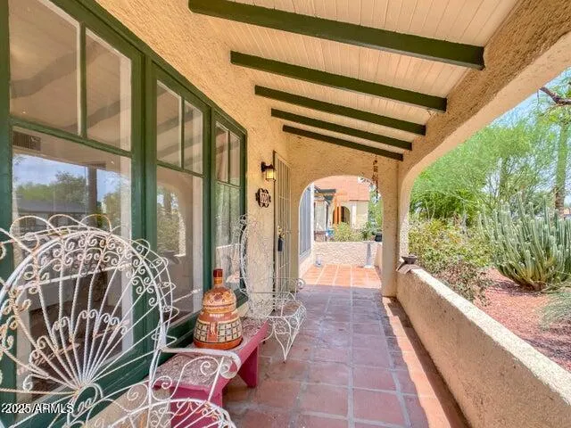 a balcony with furniture and a potted plant