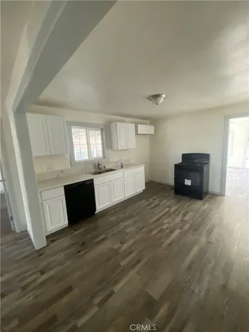 a view of a kitchen with wooden cabinet and a refrigerator