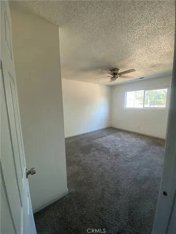 an empty room with windows and entrance