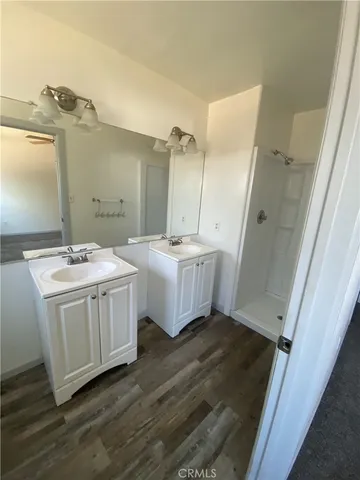 a bathroom with a double vanity sink and mirror