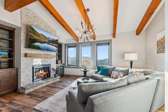 a spacious bedroom with furniture and a large window