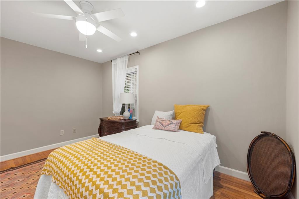 542 Goldsboro Road Northeast, Unit D Atlanta, GA 30307 - Photo 11 of 26 a bedroom with a bed and wooden floor