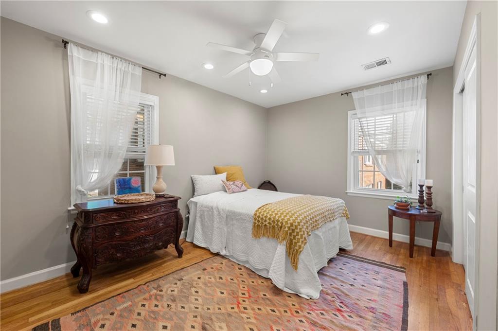 542 Goldsboro Road Northeast, Unit D Atlanta, GA 30307 - Photo 12 of 26 a bedroom with a bed and wooden floor