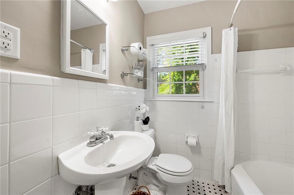 542 Goldsboro Road Northeast, Unit D Atlanta, GA 30307 - Photo 15 of 26 a bathroom with a sink a toilet and a mirror