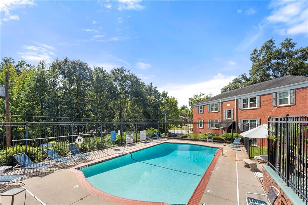 542 Goldsboro Road Northeast, Unit D Atlanta, GA 30307 - Photo 21 of 26 a view of a swimming pool with a patio