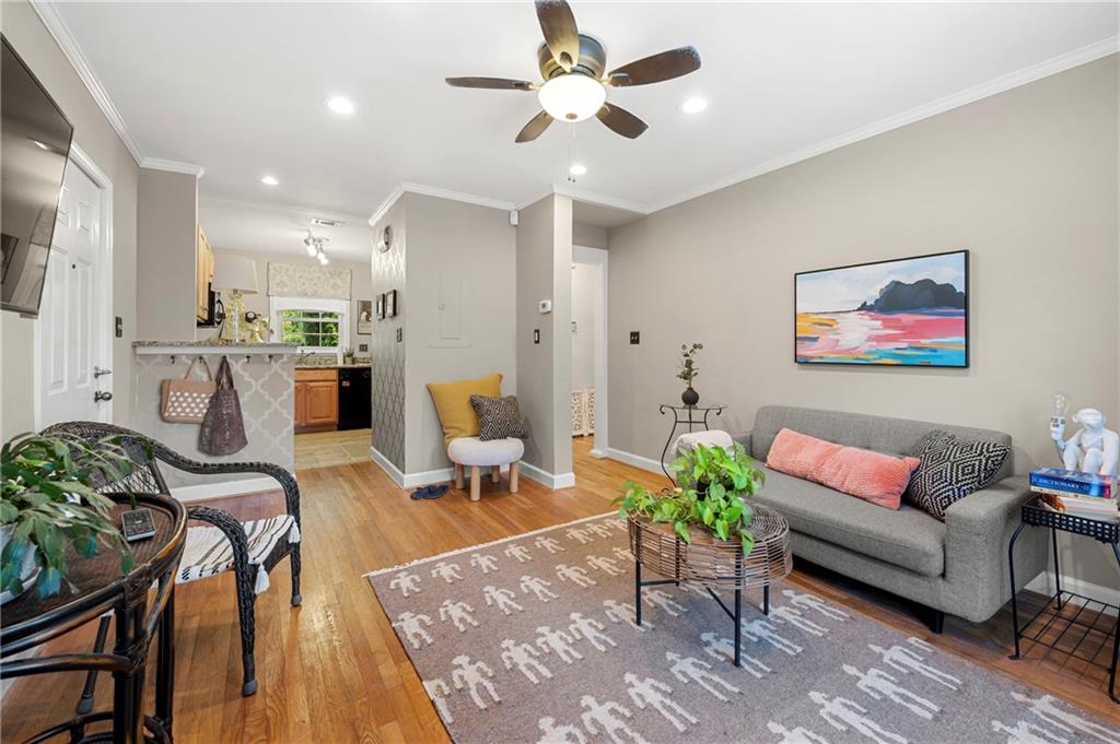 542 Goldsboro Road Northeast, Unit D Atlanta, GA 30307 - Photo 3 of 26 a living room with furniture potted plant and kitchen view