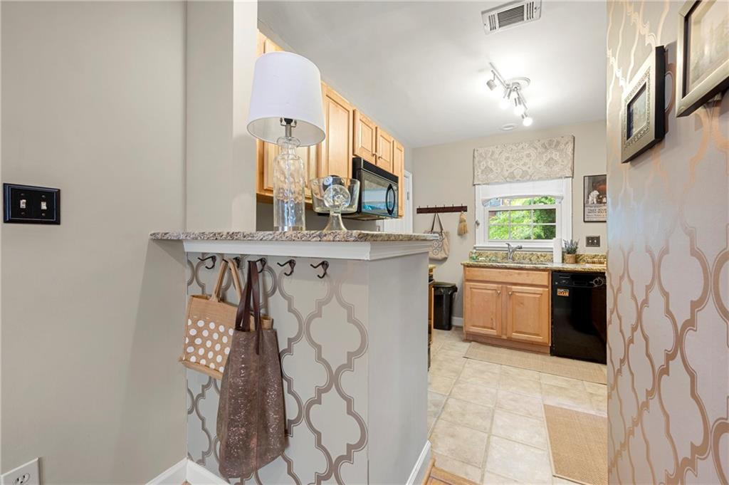 542 Goldsboro Road Northeast, Unit D Atlanta, GA 30307 - Photo 6 of 26 a kitchen with stainless steel appliances a sink and a stove