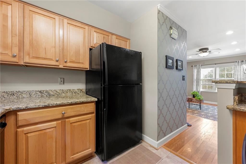 542 Goldsboro Road Northeast, Unit D Atlanta, GA 30307 - Photo 10 of 26 a kitchen with stainless steel appliances granite countertop a refrigerator and a stove