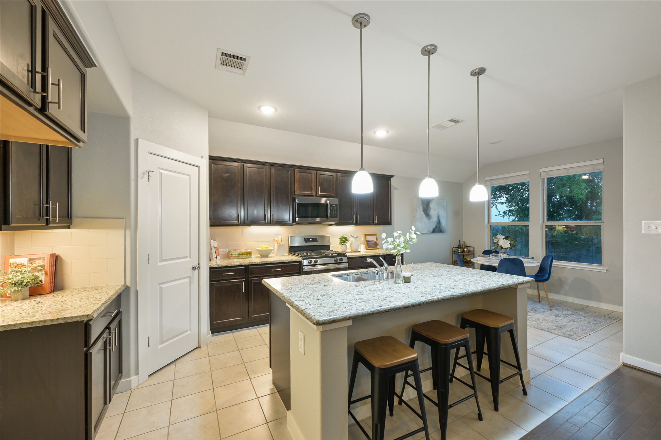 188 Nautical Loop Kyle, TX 78640 - Photo 16 of 38 A well-appointed kitchen features a large island and ample cabinet space, flowing into a bright dining nook.