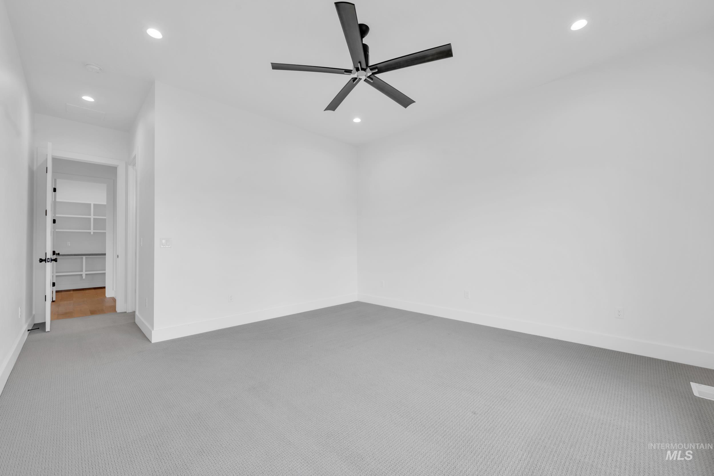 4447 East Copper Point Drive Meridian, ID 83642 - Photo 18 of 41 Unfurnished room with recessed lighting, light colored carpet, and ceiling fan