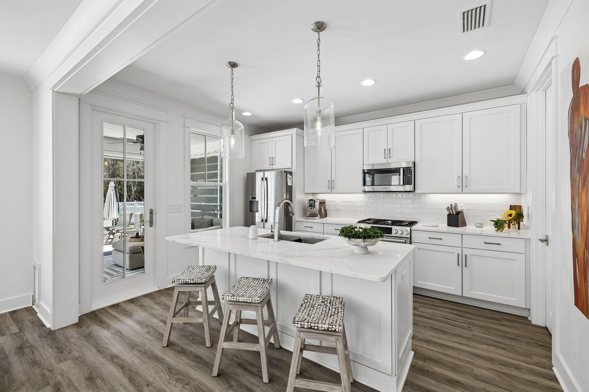 115 Log Landing St Inlet Beach Inlet Beach, FL 32461 - Photo 6 of 69 a kitchen with stainless steel appliances granite countertop a stove top oven a refrigerator a sink and chairs