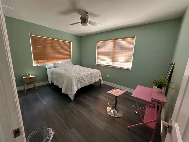 a white toilet sitting next to a bath tub