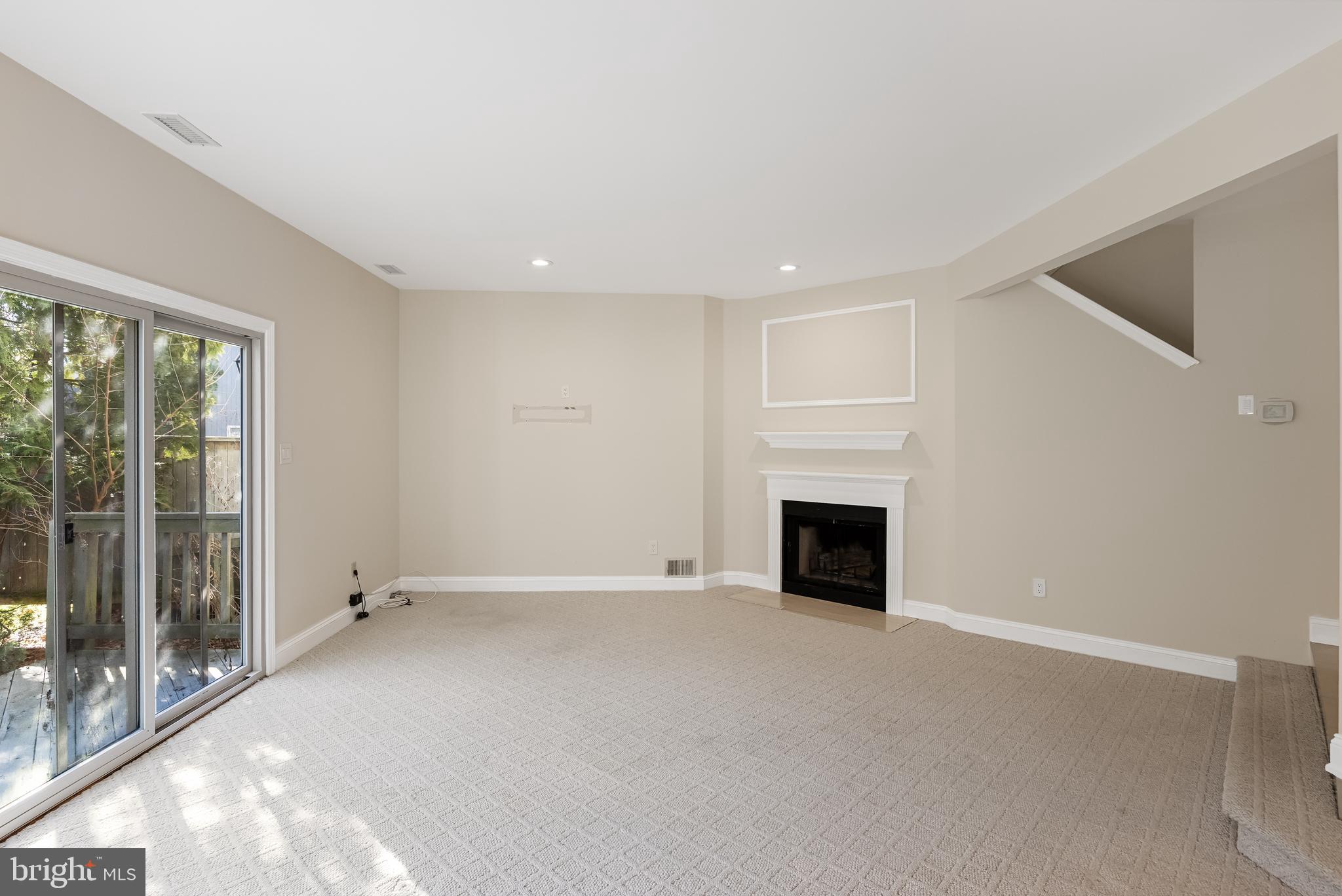 962 Chanticleer Cherry Hill, NJ 08003 - Photo 11 of 38 an empty room with fireplace wooden floor and windows