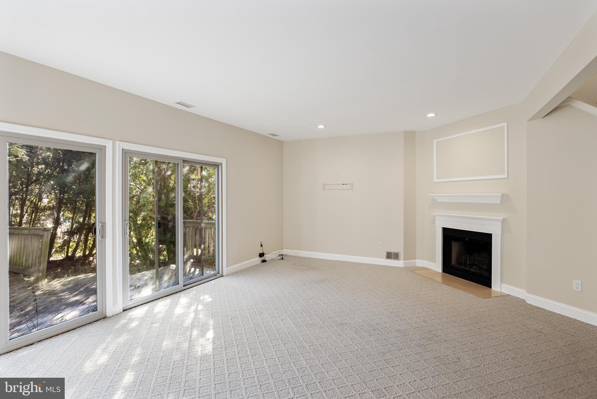 962 Chanticleer Cherry Hill, NJ 08003 - Photo 12 of 38 a view of an empty room with a fireplace and a window