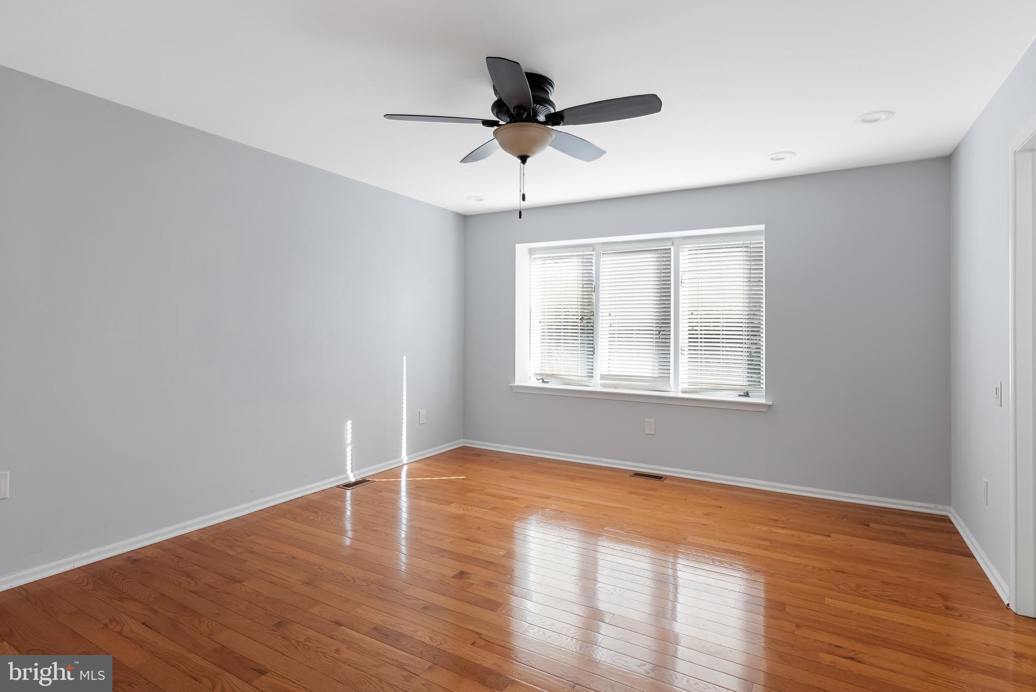 962 Chanticleer Cherry Hill, NJ 08003 - Photo 24 of 38 a view of empty room with wooden floor and fan