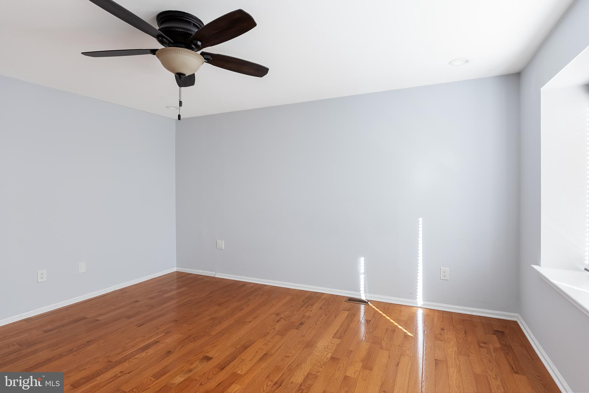 962 Chanticleer Cherry Hill, NJ 08003 - Photo 25 of 38 an empty room with wooden floor and windows