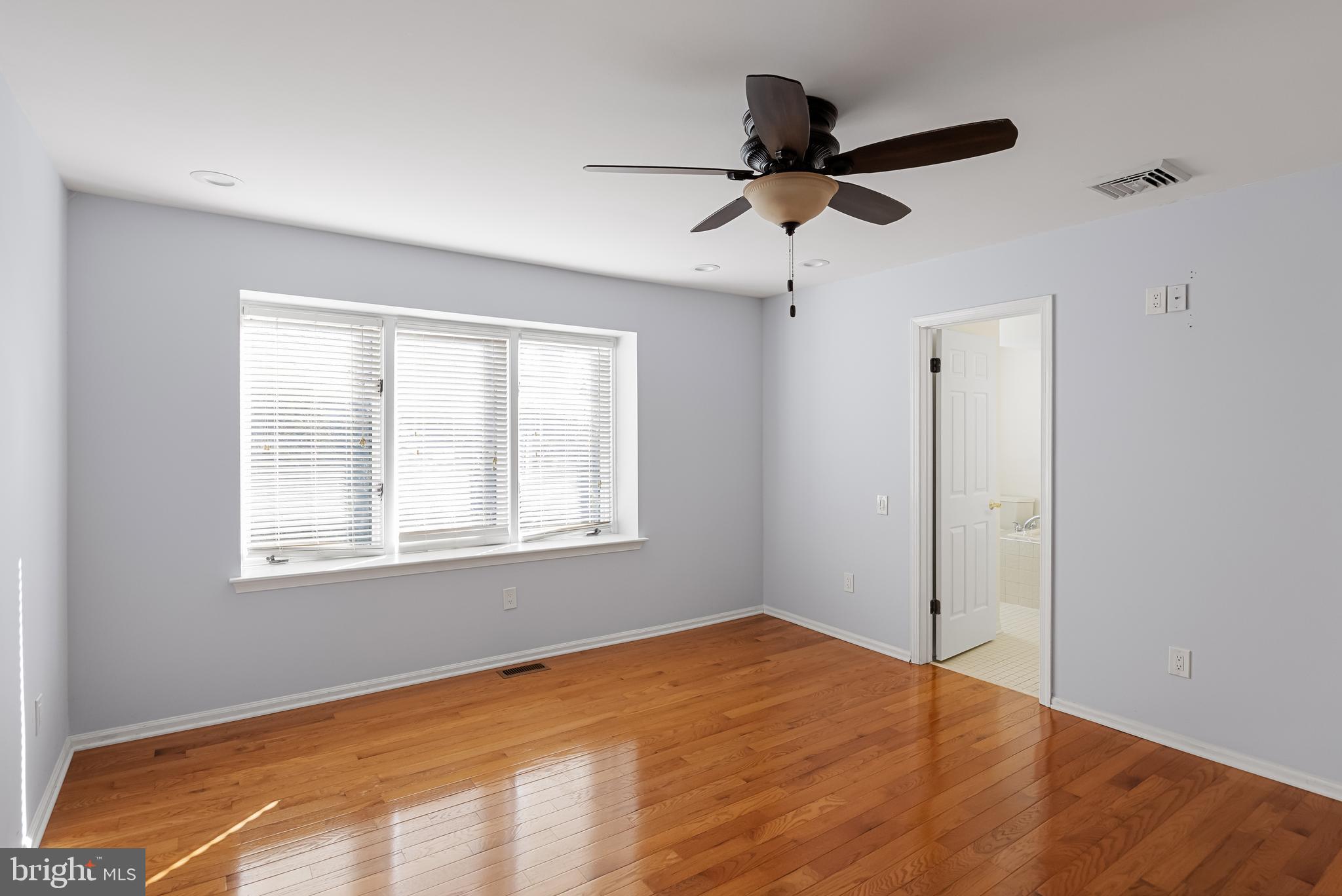 962 Chanticleer Cherry Hill, NJ 08003 - Photo 26 of 38 a view of empty room with wooden floor and fan