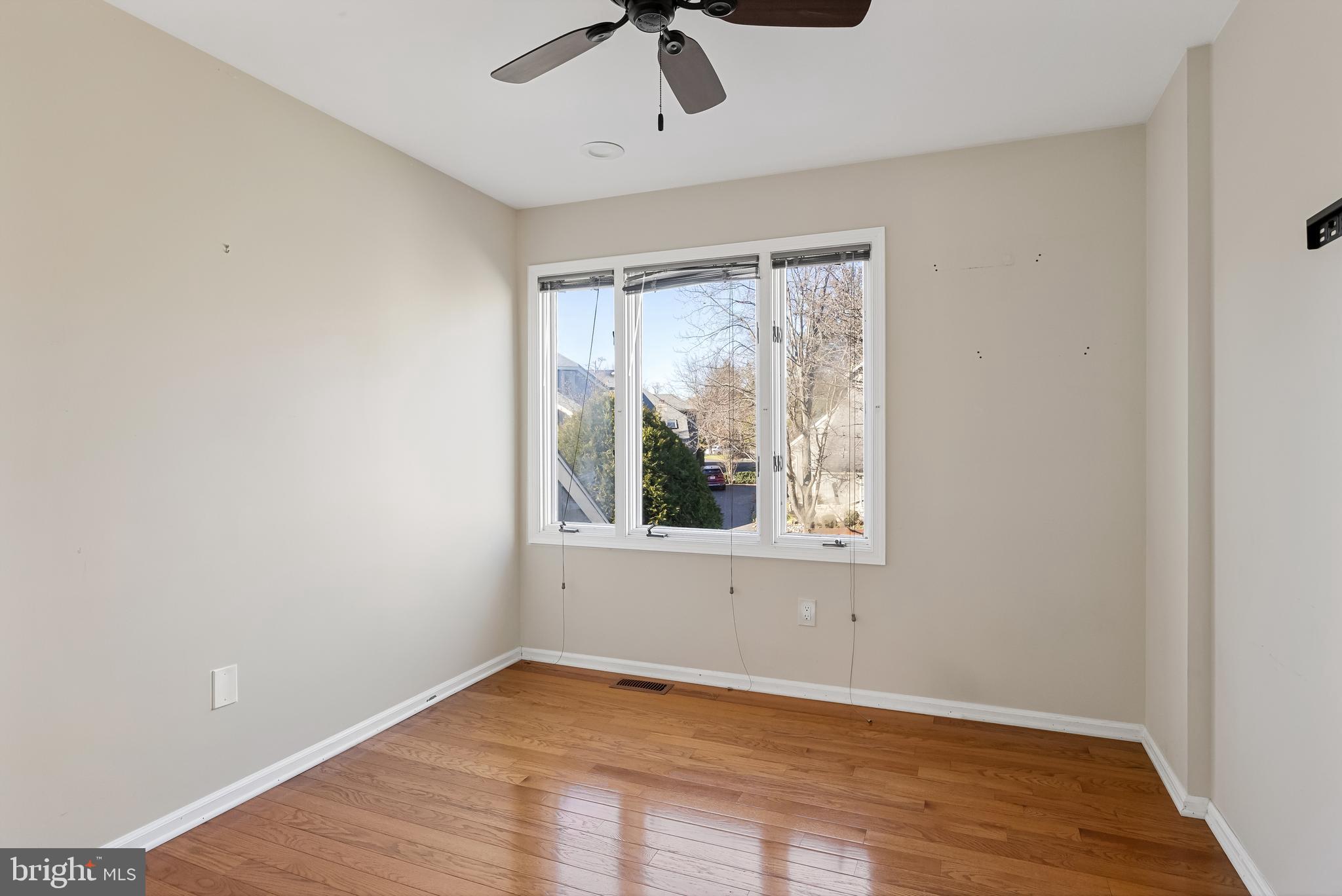 962 Chanticleer Cherry Hill, NJ 08003 - Photo 30 of 38 an empty room with wooden floor chandelier fan and windows