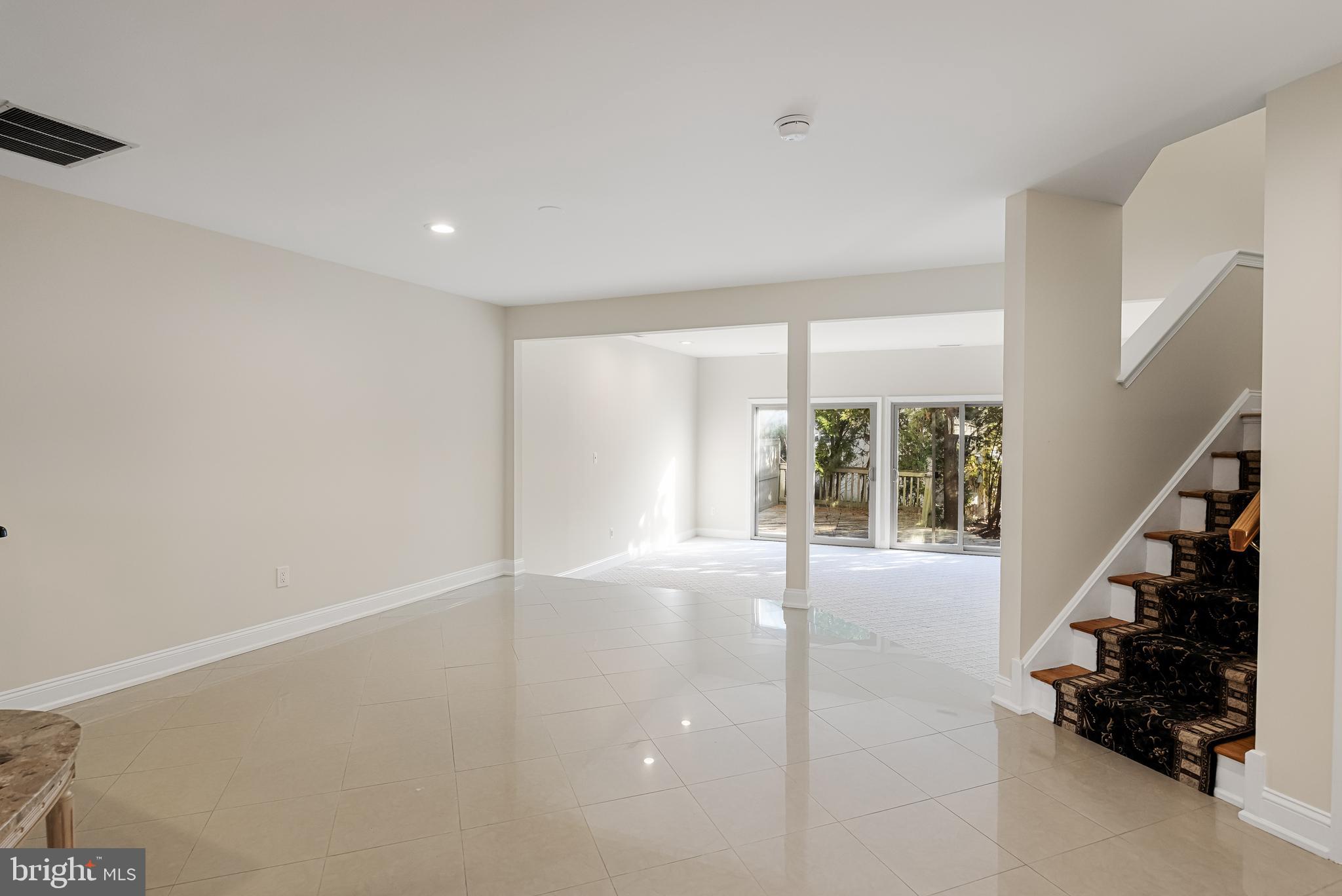 962 Chanticleer Cherry Hill, NJ 08003 - Photo 7 of 38 a view of an empty room with wooden floor and windows
